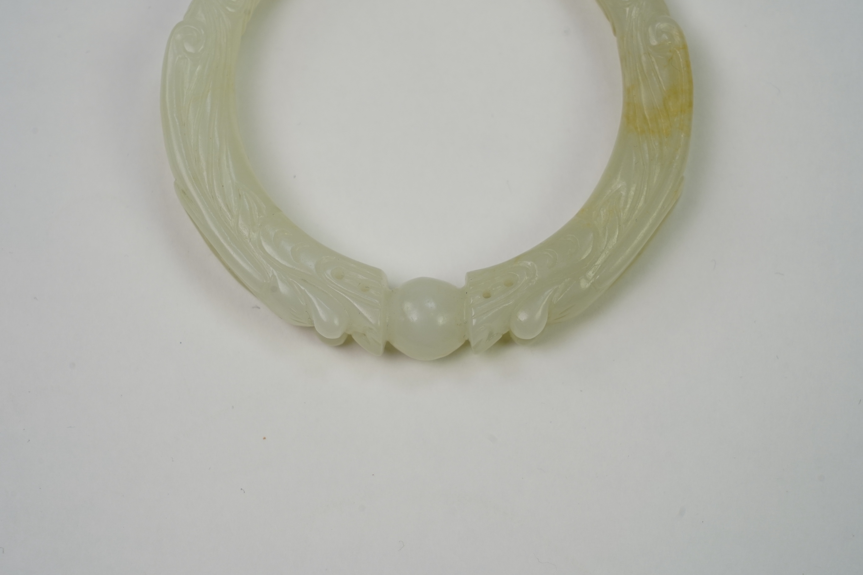 A Chinese pale celadon jade ’dragon’ bangle
